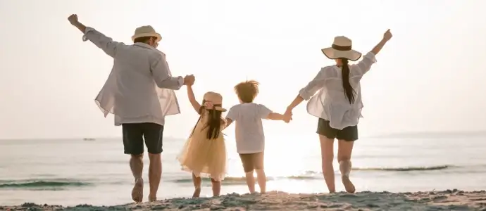 Young family with kids on the beach